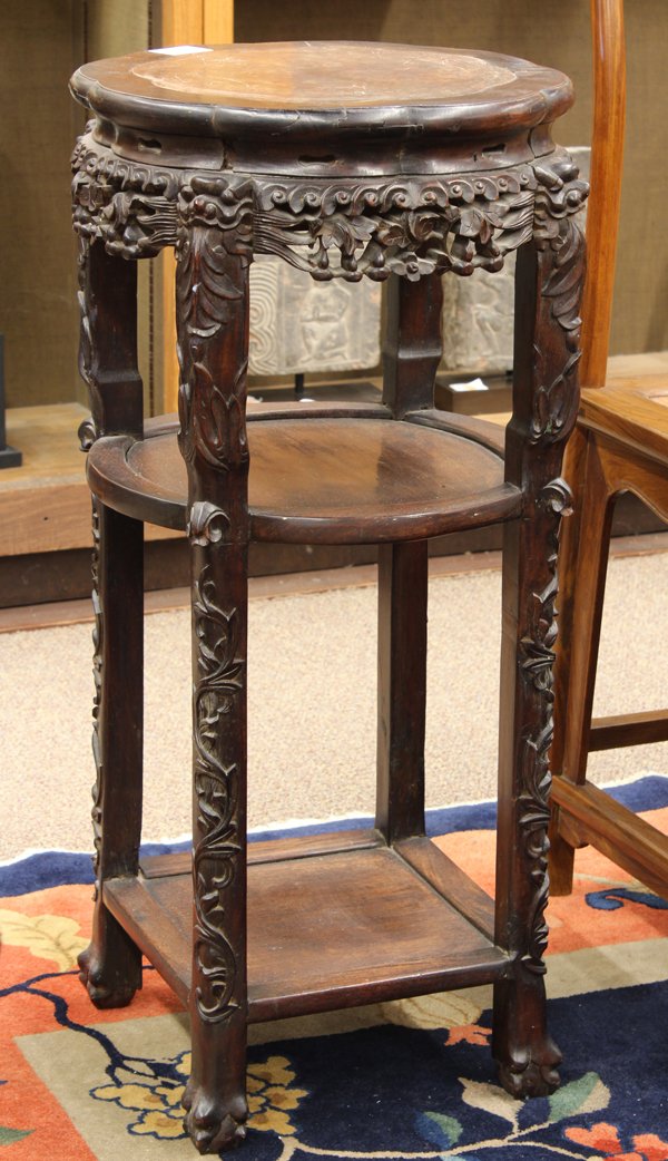 Chinese Marble Inlaid Export Wood Stand: Chinese marble inset wooden export tiered stand, with a floral form dark marble plaque within a conforming frame, above the waist pierced with double gourds, the supports topped with the heads of myth