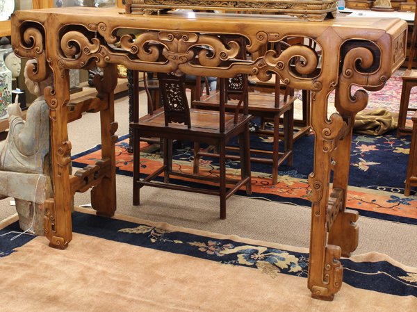 Chinese Wooden Altar Table: Chinese softwood altar table, the apron reticulated with stylized scrolls linked with a ring to the center, all raised on supports accented with ruyi heads and joined by side stretchers, 47''h x 70.25