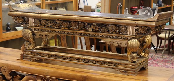 Japanese Gilt Lacquered Wood Altar: Japanese gilt and lacquered wooden small altar table/stand, fronted by an apron elaborately carved with lotus in high relief, while joined to cabriole supports raised on a rectangular frame base furth