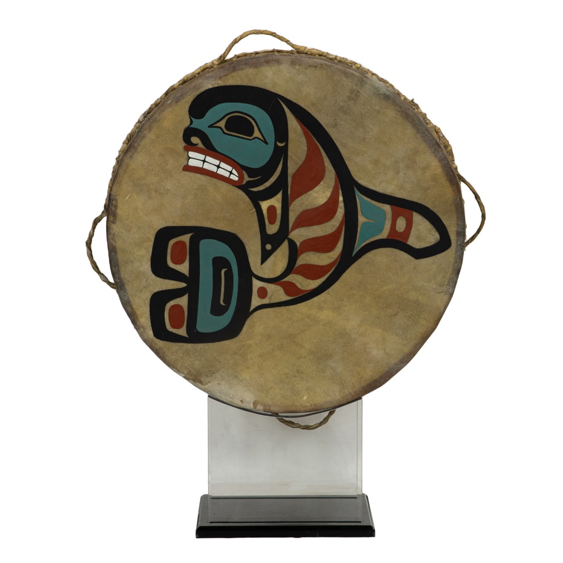 A massive Northwest Coast Haida ceremonial dance drum: A massive Northwest Coast Haida ceremonial dance drum painted with figure of a an orca whale 30"dia mounted on a lucite stand, overall 40"h x 30"d x 12"d