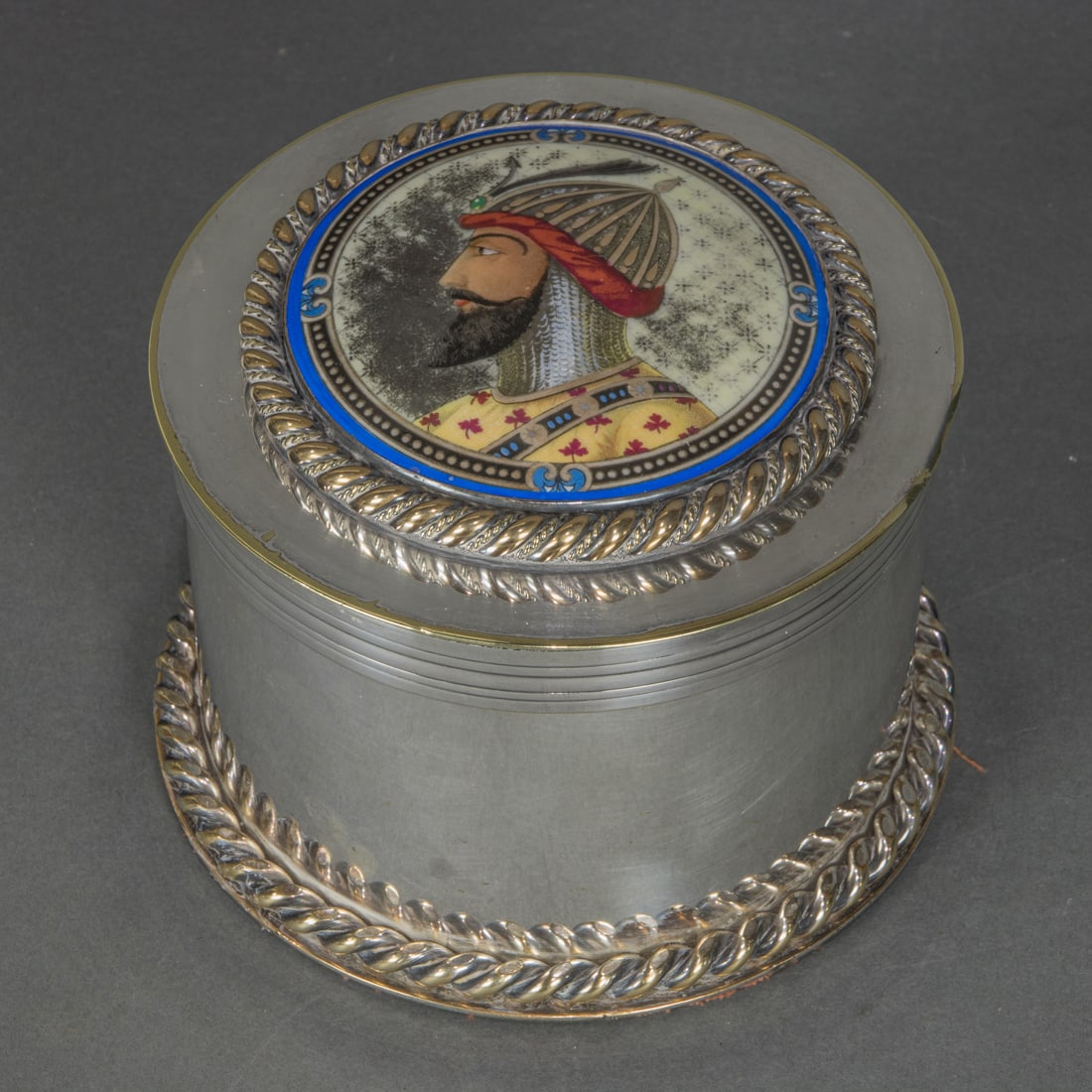 A large Anglo-Indian enamel silver plated circular humidor with enameled soldier: A large Anglo-Indian enamel silver plated circular humidor with enameled soldier 4.5"h x 6"dia