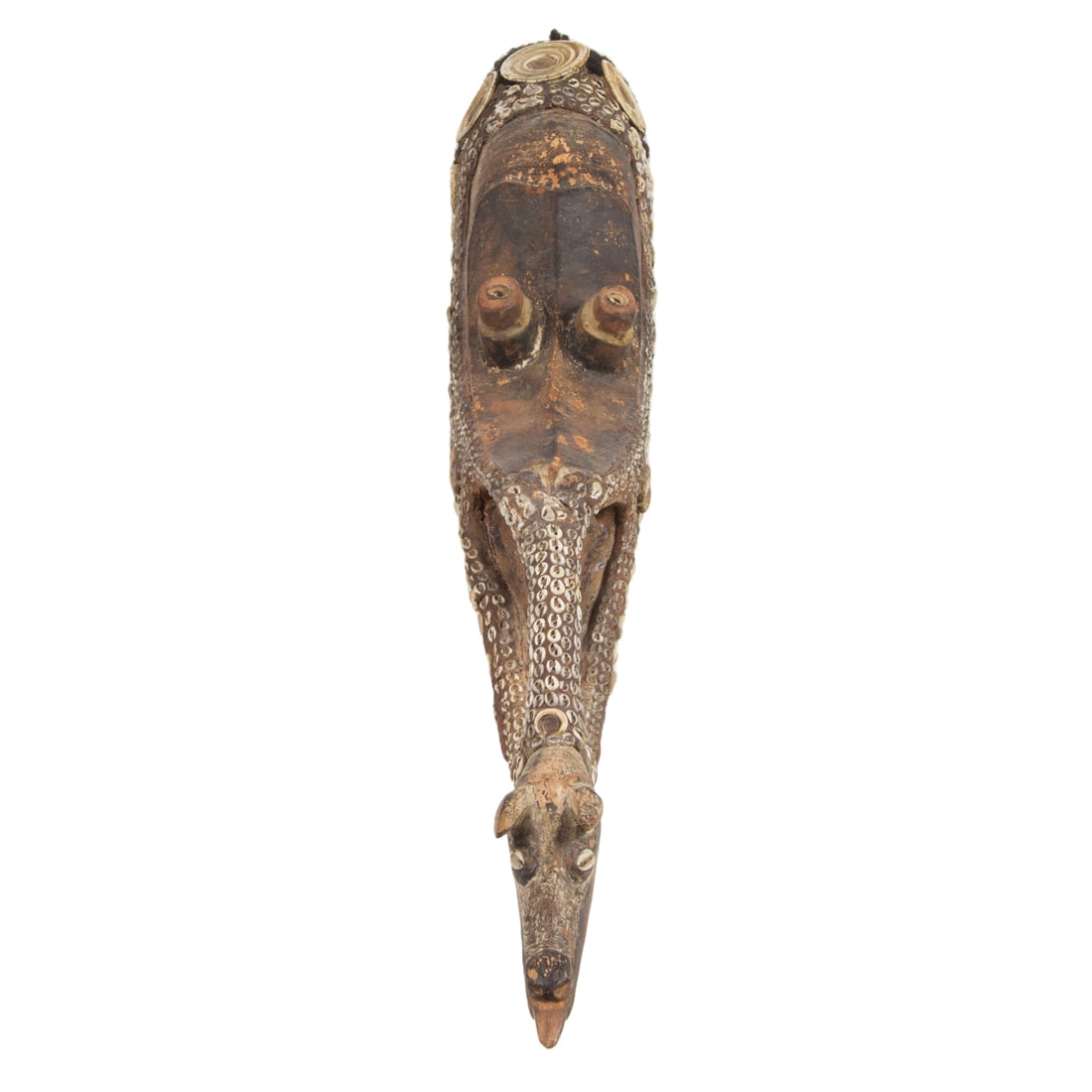 A Sepik River animal mask with applied cowrie shells: A Sepik River animal mask with applied cowrie shells, hair and teeth, 30"h and a Sepik River totem figure modeled as winged bird wrapped with a cowrie shell necklace above a figure with grass skirt, 3