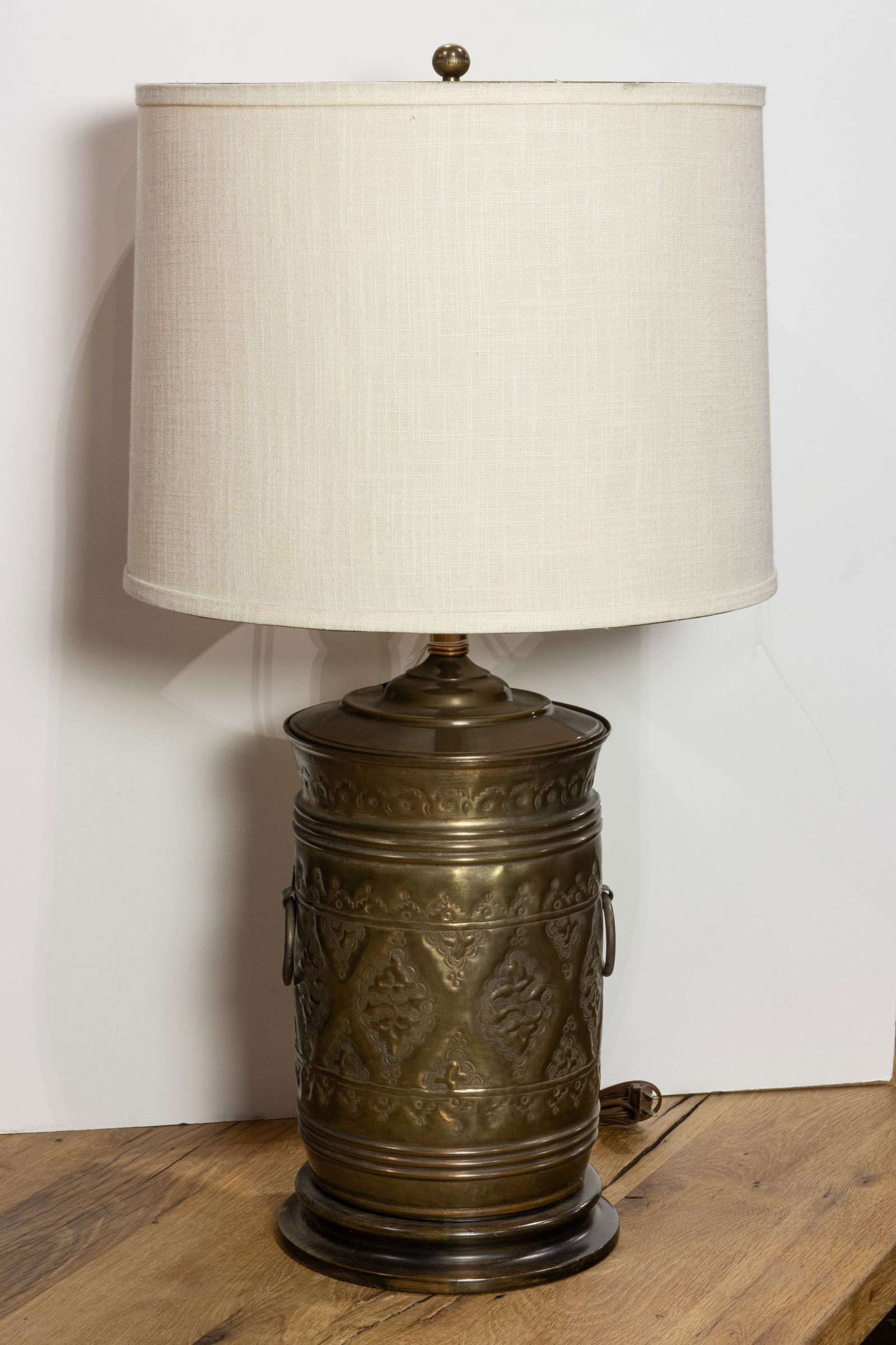A Middle Eastern repousse copper canister form table lamp fitted with linen shade (1 of 1)