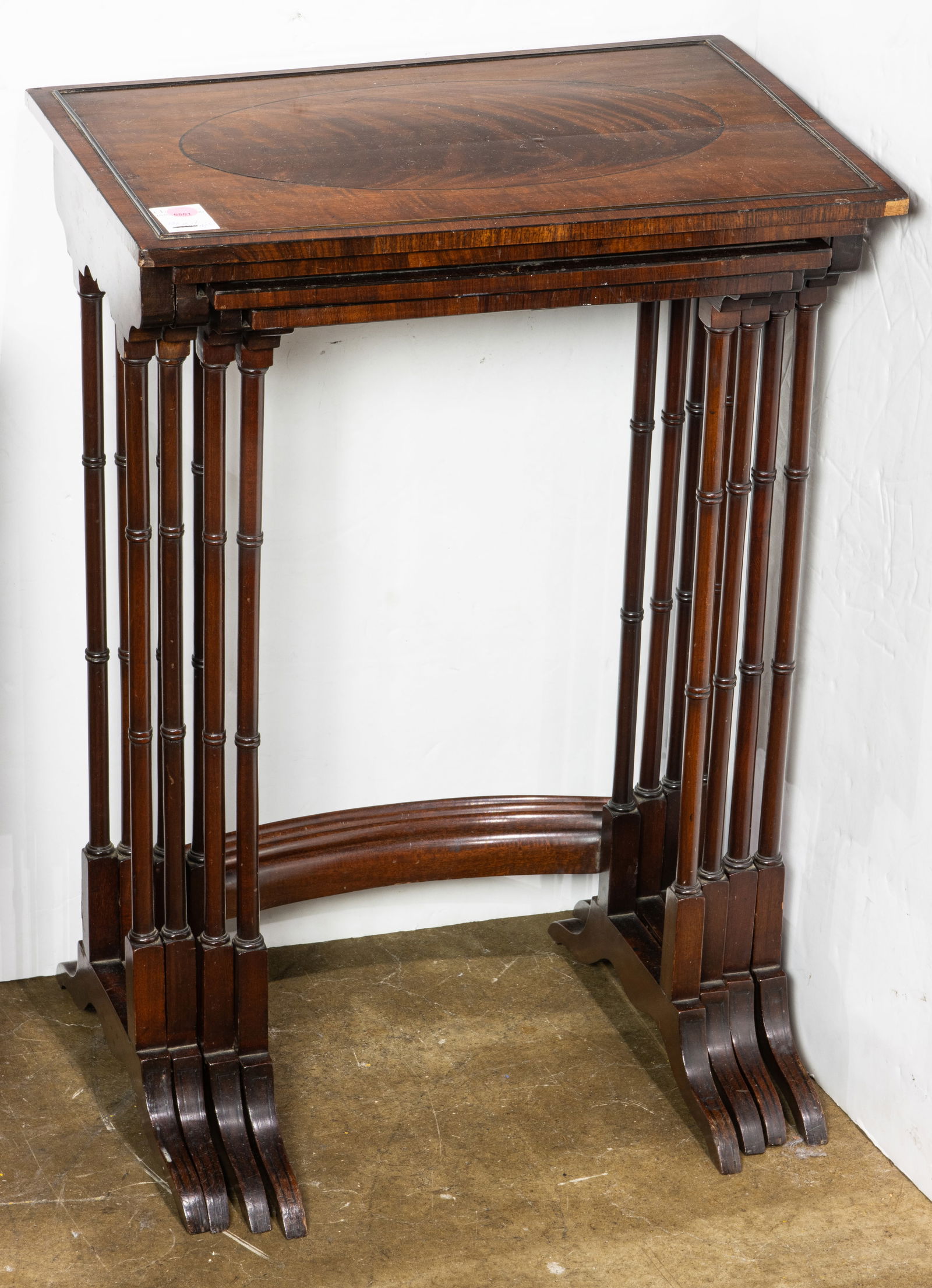 An Edwardian crossbanded and inlaid satinwood nest set of four spindle leg tables: An Edwardian crossbanded and inlaid satinwood nest set of four spindle tea tables, the largest 27"h x 19.75"w x 13.5"d