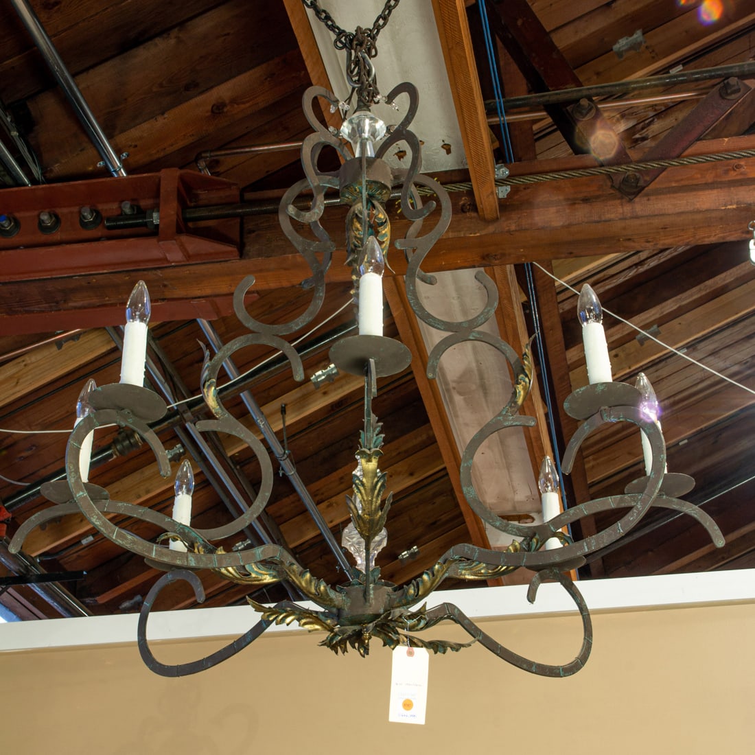 An imposing Continental parcel gilt iron chandelier: An imposing Continental parcel gilt iron chandelier, of scrolling cage form fitted with eight lights, approximately 48" h x 48"w