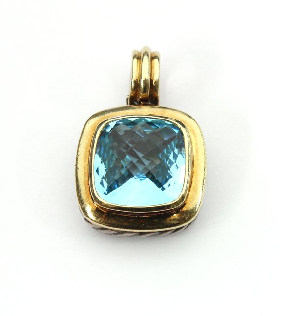 18K and silver David Yurman topaz pendant enhance: Blue topaz DAVID YURMAN ''Albion'' pendant/enhancer; mounted in silver and 18K yellow gold, bezel set with (1) 14 mm. cushion shape checkerboard cut blue topaz, approximately 13.03 ct. Pendant weighs