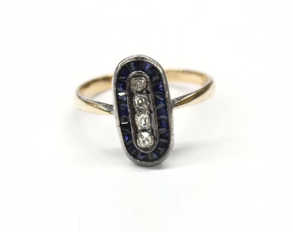 14K yellow gold, diamond and sapphire ring: Lady's diamond and sapphire ring; mounted in 14K yellow gold and center set with a vertical row of Old Mine cut diamonds totaling 0.16 ct. surrounded by a row of caliber cut sapphires weighing 0.54 ct