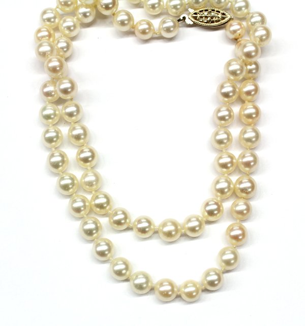 Saltwater cultured pearl necklace with 14K clasp: Lady's uniform strand-style necklace; mounted with 14K (stamped ''14K'') yellow gold filigree fish hook clasp and consisting of (66) spherical drilled saltwater cultured pearls measuring 7.20 - 7.52 m