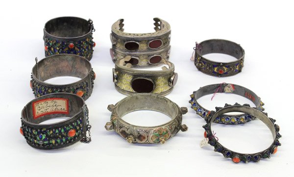 Central Asian arm cuffs and bangles: (lot of 9) Central Asian arm cuffs and bangles composed of mixed metals, some with enameling and stone cabochons Provenance: Estate of Rebecca and Seymour Fromer (founder of the Judah Magnes Museum, B