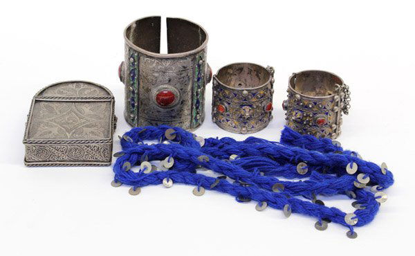 Collection of Middle Eastern style jewelry: (lot of 4) Vintage Moroccan arm cuff and a pair of bangles composed of chased and enameled silvered metal decorated with red stone cabochons; together with a silvered metal hinged carrying box Provena