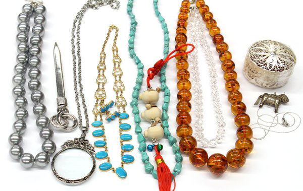 Lot of various fashion jewelry and trinkets: Lot of fashion jewelry and trinkets, including (1) faux amber bead necklace, (1) black onyx and silver bead necklace, (2) silver letter openers, faceted glass bead necklaces, pair of opera glasses, pa