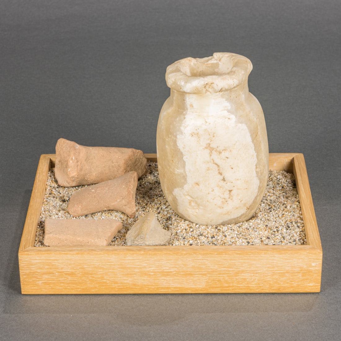An Egyptian alabaster jar, possibly ancient 4: An Egyptian alabaster jar, possibly ancient 4.5"h; together with pottery chards of unknown origin