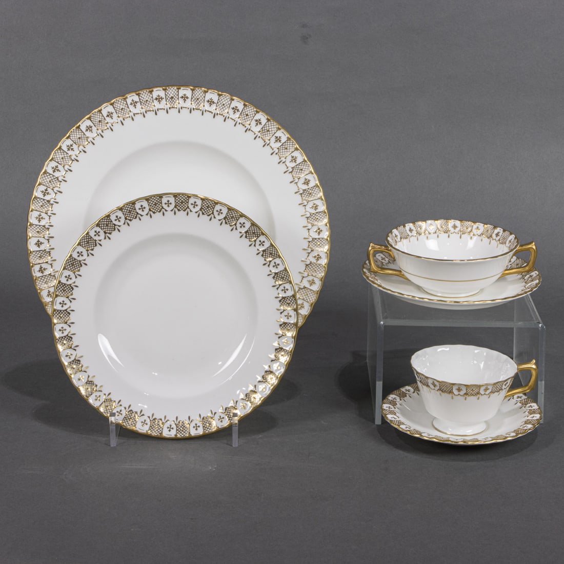 A Royal Crown Derby porcelain dinner service in the Heraldic Gold pattern (1 of 4)