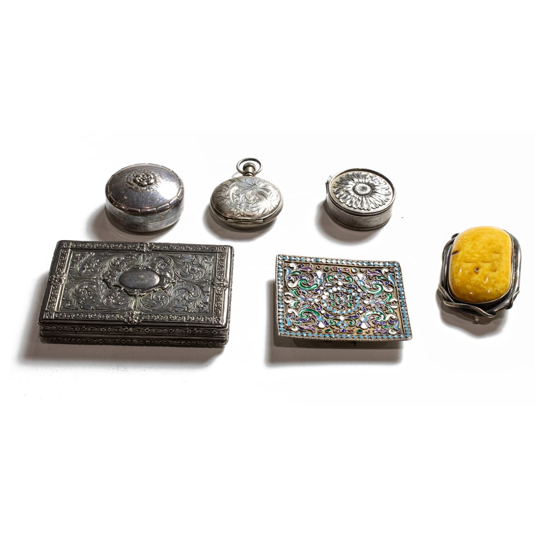 A lot of silver jewelry items and boxes, comprising a Russian cloisonne barette: A lot of silver jewelry items and boxes, comprising a Russian cloisonne barette; a Georg Jensen sterling pill box with a floral finial; a .900 standard silver box; a Baltic amber brooch, a Leader coin