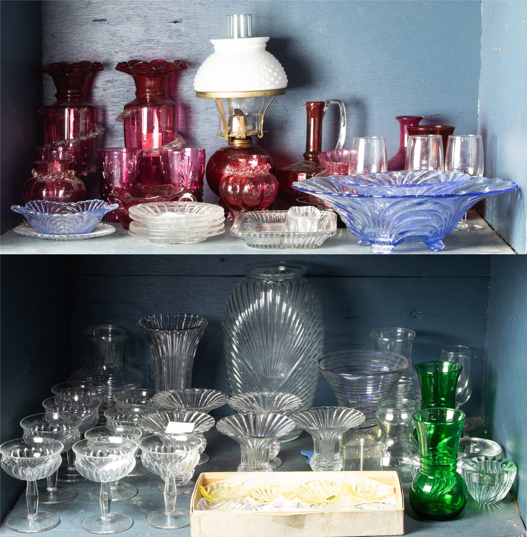 Three shelves of Depression and Victorian clear and cranberry glass: Three shelves of Depression and Victorian clear and cranberry glass, including oil lamp, serving dishes, vases, wine glasses, etc.