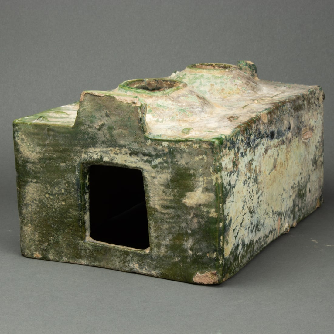 Chinese green glazed pottery model of a stove: Chinese green glazed pottery model of a stove. Han dynasty, 10.5 across.