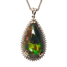 A black opal, diamond and white gold pendant and chain