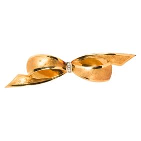 A diamond and 18k gold bow brooch, Italy