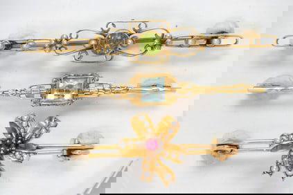 Three gemstone and 14k gold brooches