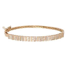 A diamond and 14k gold bangle bracelet