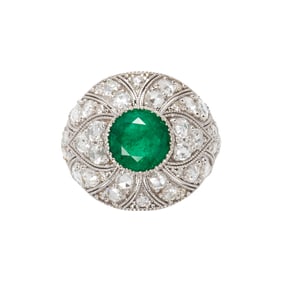 An emerald, diamond and 14k white gold ring