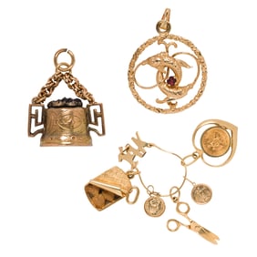 A group of 14k gold charms and pendant holder