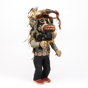 An early Hopi Wolf Kachina wearing a leather cape and a knitted scarf