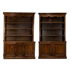 A large assembled pair of Louis XV style mahogany breakfront bookcase cabinets