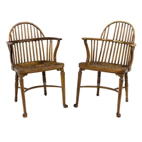 A pair of English mixed wood bow back Windsor armchairs