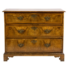 A George II walnut chest of drawers circa 1760, the string and crossbanded case with three drawers