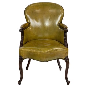 An English leather upholstered arm chair in the Rococo Revival taste circa 1860