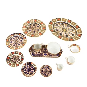 A Royal Crown Derby assembled porcelain dinner service in the Old Imari pattern 1128