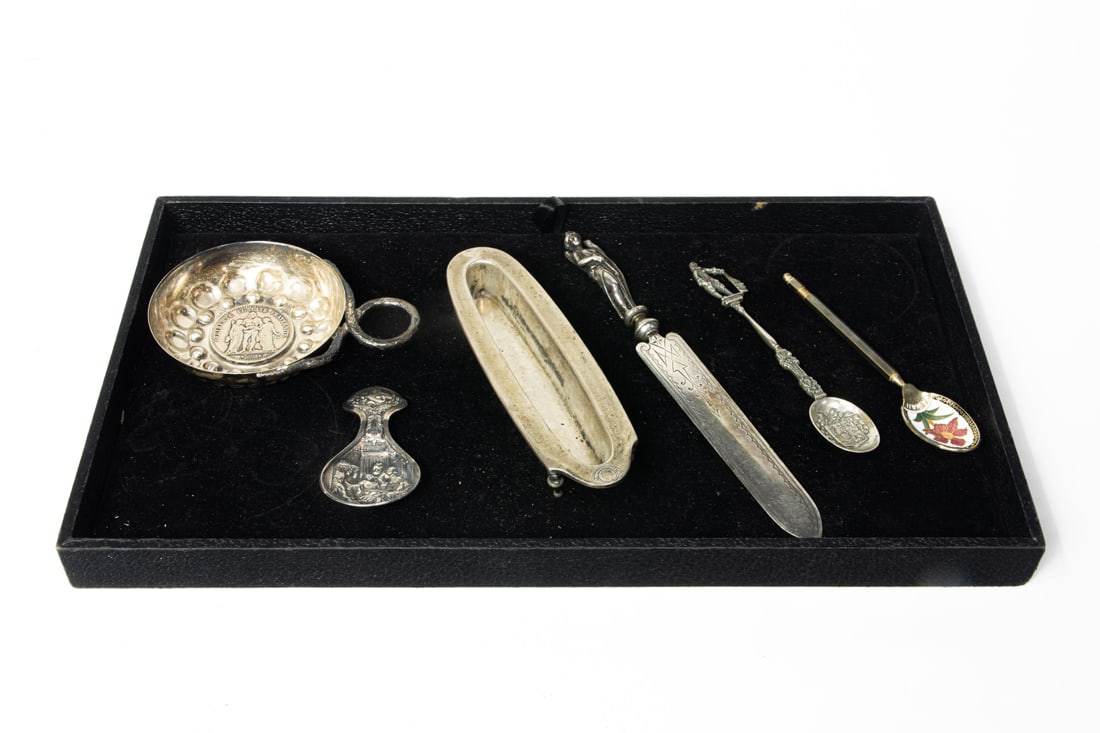A lot of sterling table articles, including a Whiting letter opener with a figure of Diana 8"l; an: A lot of sterling table articles, including a Whiting letter opener with a figure of Diana 8"l; an European repousse tea caddy spoon; a La Pierre stand for nail buffer; two souvenir spoons en suite wi