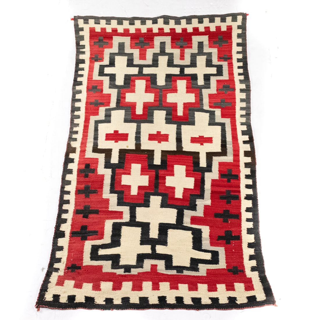 A Navajo red white and black eye dazzler rug with crosses: A Navajo red white and black eye dazzler rug with crosses, 69" x 39"