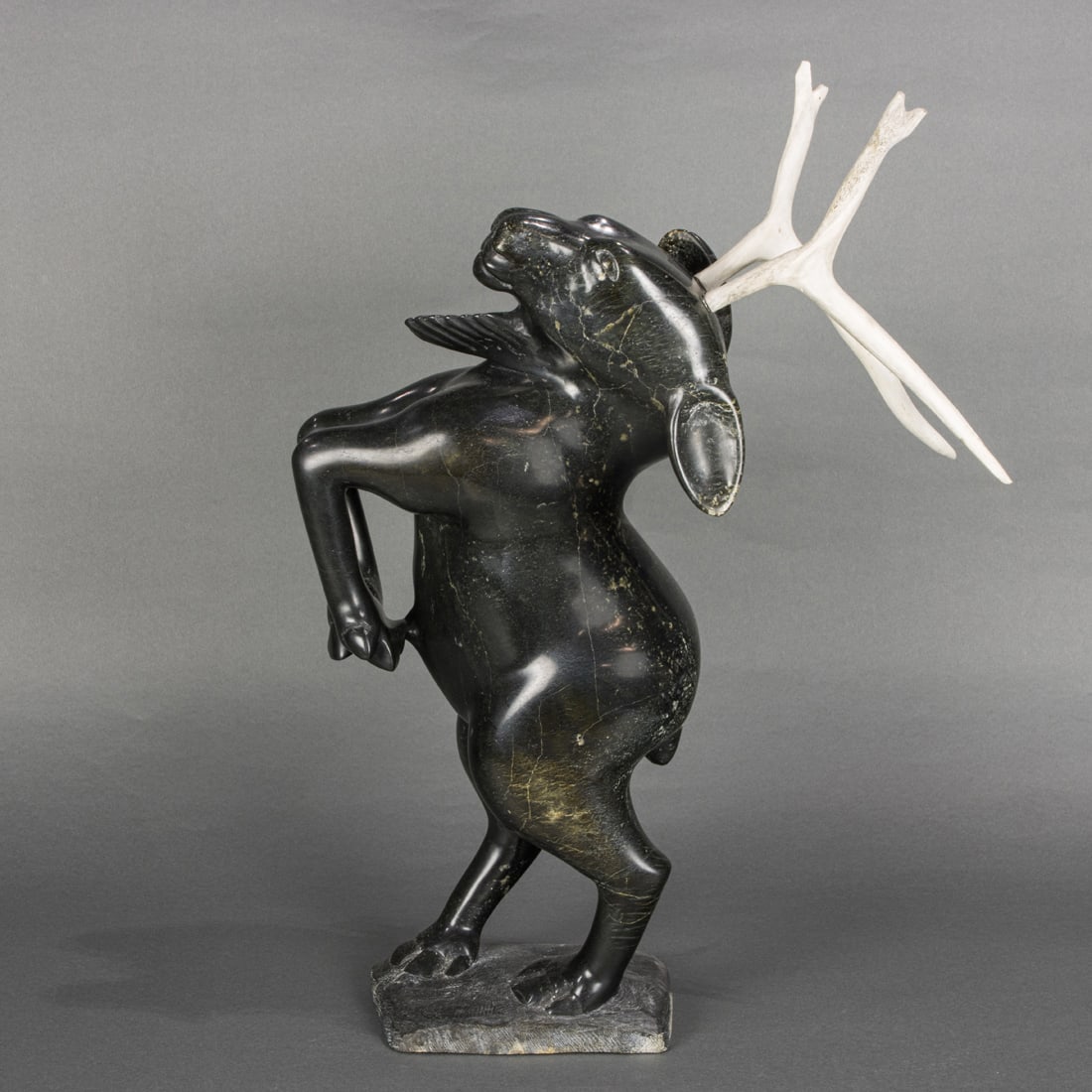 An Aquangajuk Shaa R.C.A. carved serpentine figure: Dancing Caribou Shaman (1 of 5)