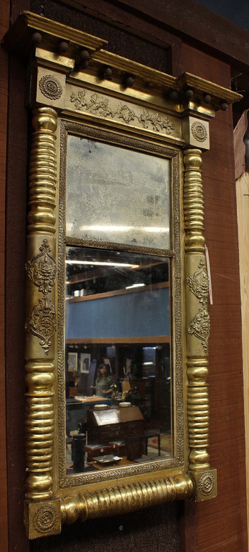 Federal looking glass: Federal looking glass circa 1810, the molded cornice with spherical drops above the composition tablet surmounting the two part looking glass framed by turned half columns retaining the original surfa