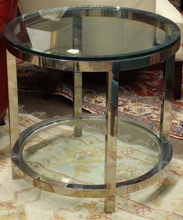 Moderne occasional table: Moderne occasional table, the circular plate glass top above a chromed base having square supports continuing to the lower tier and rising on square legs, 25.5''h x 28''w Provenance: From the Design C