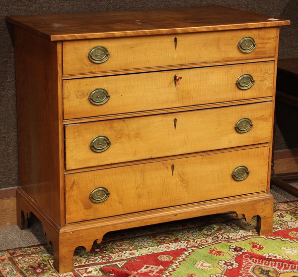 Federal chest of drawers: Federal chest of drawers circa 1840, executed in satin wood, the rectangular top above the four drawer case having a marquetry decorated escutcheon and rising on bracket feet, 35''h x 39''w x 22.5''d