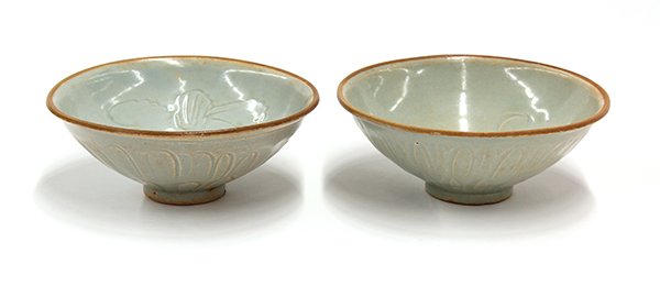 Southeast Asian Celadon Molded and Incised Bowls: (lot of 2) Southeast Asian celadon glazed molded and incised ceramic tradeware bowls, each molded with flower petals to the exterior, one carved with ducks to the well, the other with scrolls and a co