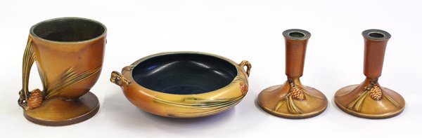 Roseville ''Pinecone'' pottery decorations: (Lot of 4) Roseville brown glazed ''pinecone'' pottery decorations, including low bowl with twig handles, 7.5''d, pair of candlesticks, 5''h, and a vase, 5''h