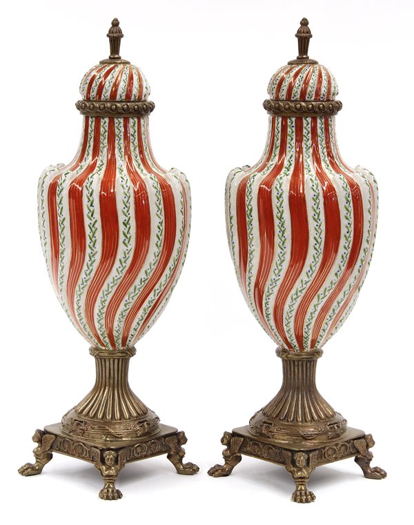 Gilt bronze mounted covered urns: Pair of gilt bronze mounted covered urns, the shouldered form having a polychrome decorated body terminating at the gilt bronze base rising on paw feet, 19''h x 6''w