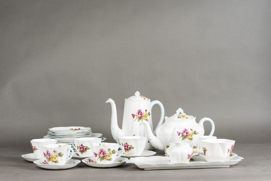 Shelley Bone China Tea Set, Begonia Pattern: (lot of 31) Shelly bone China tea set, begonia pattern. Comprising a Coffee pot, Tea pot, cream, sugar, under tray, cups, saucersand luncheon plates. Highest: 8.27"h (21 cm) 