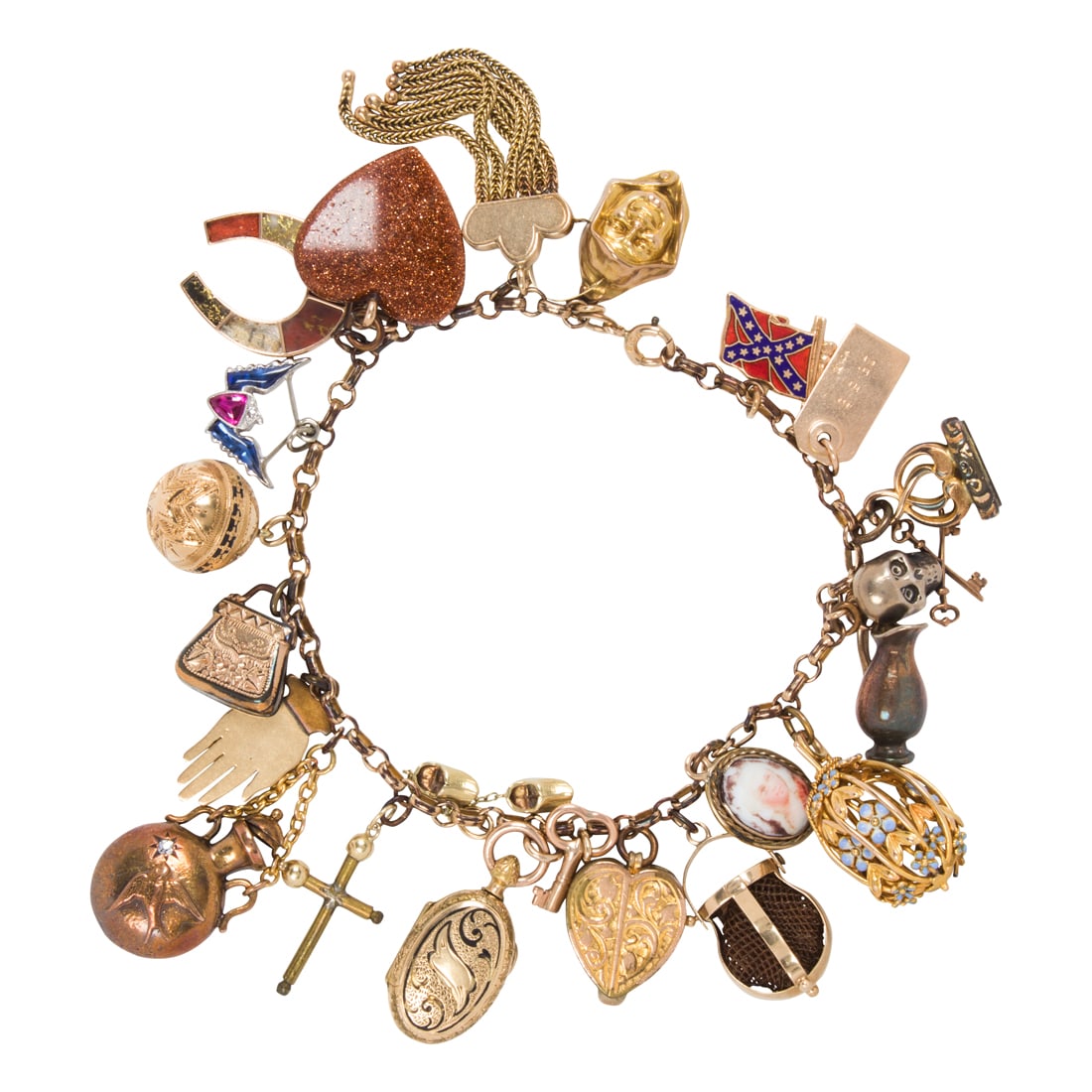 A charm bracelet: A charm braceletthe gold-filled chain suspending (23) 14k, 10k, platinum and metal charms, including diamond-set perfume holder, an enameled cage, a gold-in-quartz inlay horseshoe (two panels missing)