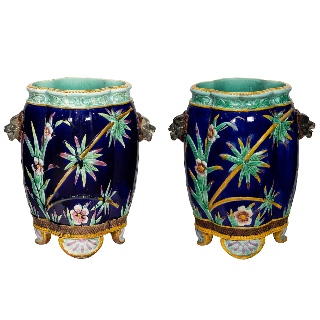 A tall pair of English majolica jardinieres, probably Thomas Forester, each quatrefoil vessel: A tall pair of English majolica jardinieres, probably Thomas Forester, each quatrefoil vessel flanked by lion head handles and decorated with cranes among flowering branches, unmarked, 23"h x 20"w. Pr