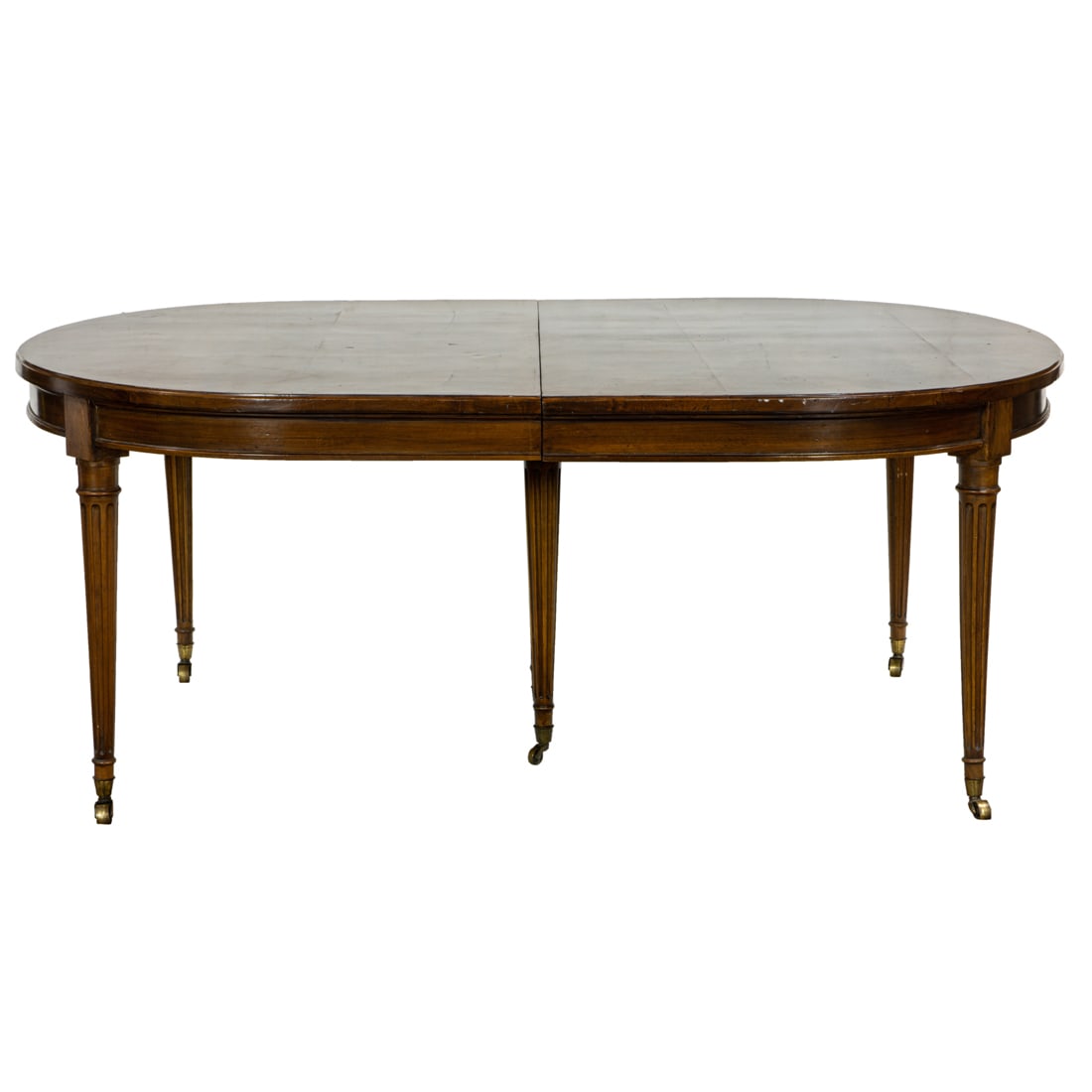 A Regency syle mahogany extension dining table, of oval form rising on tapered fluted legs, overall: A Regency syle mahogany extension dining table, of oval form rising on tapered fluted legs, overall with three leaves 29.5"h x 127"w x 54.5"d