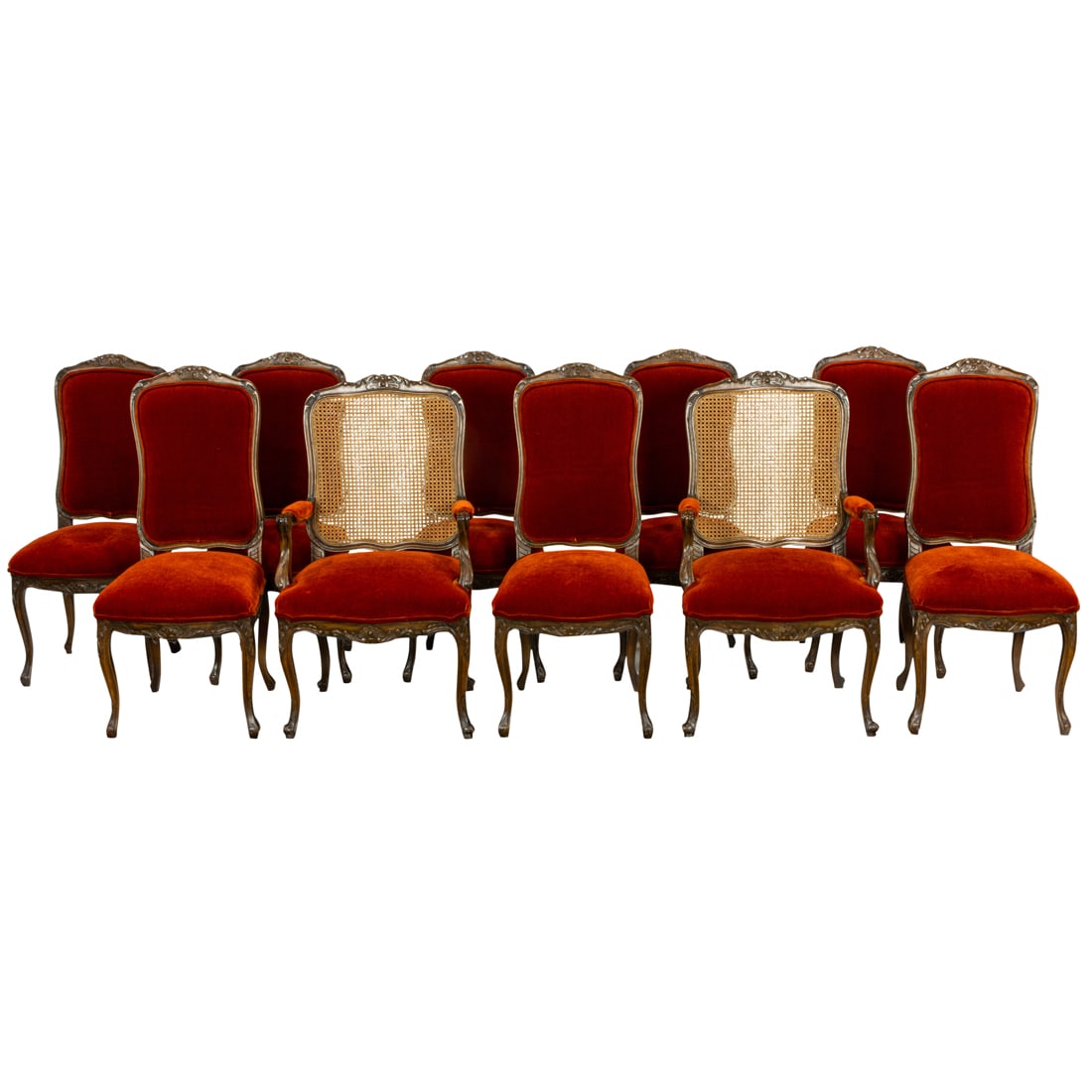 A suite of ten Louis XV style walnut dining chairs: A suite of ten Louis XV style walnut dining chairs, upholstered in rust velvet, comprising two fauteuils with caned backs 41.5"h x 26.5"w x 19"d; and eight side chairs 43"h x 19"w x 18"d, seat height 