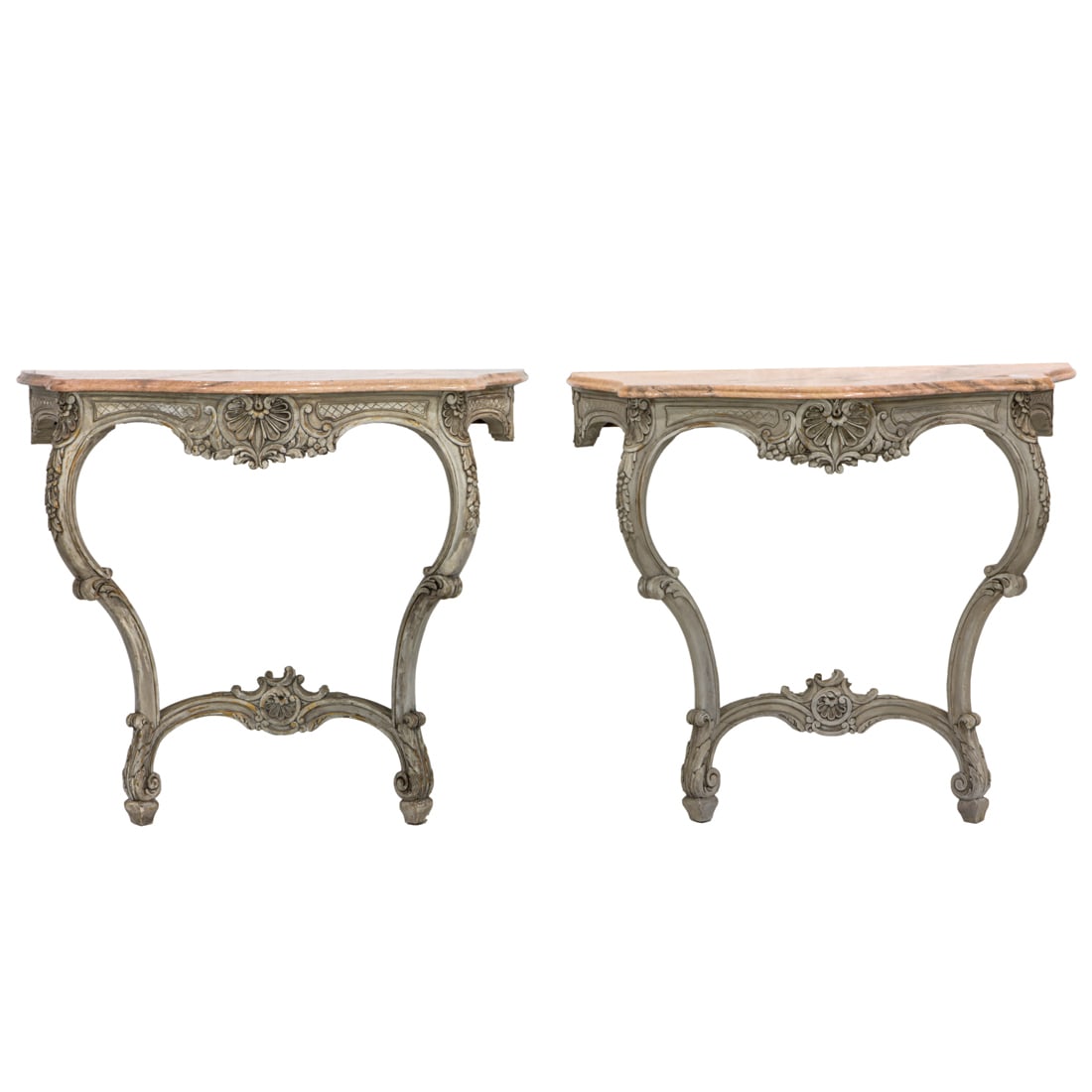 A pair of Louis XV style polychrome decorated console tables: A pair of Louis XV style polychrome decorated console tables, each with a serpentine marble top resting on the carved base with floral and geometric carved reserves, and rising on inswept acanthus dec