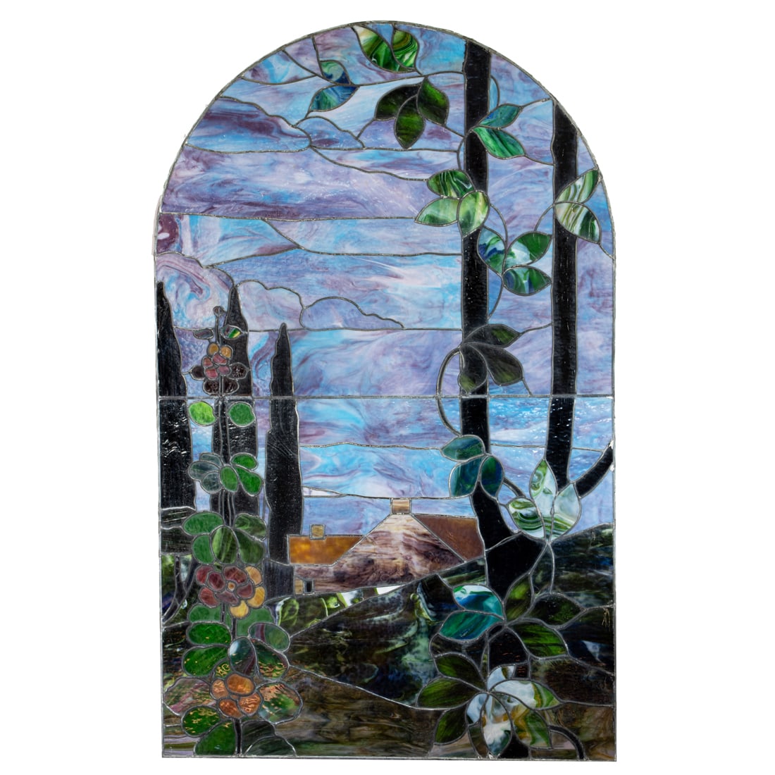 An American leaded glass window panel, of arch form depicting an arbor in the foreground with: An American leaded glass window panel, of arch form depicting an arbor in the foreground with flowers and red trees, a house in background, under a sky of horizontal and cloud shaped blue, purple and 