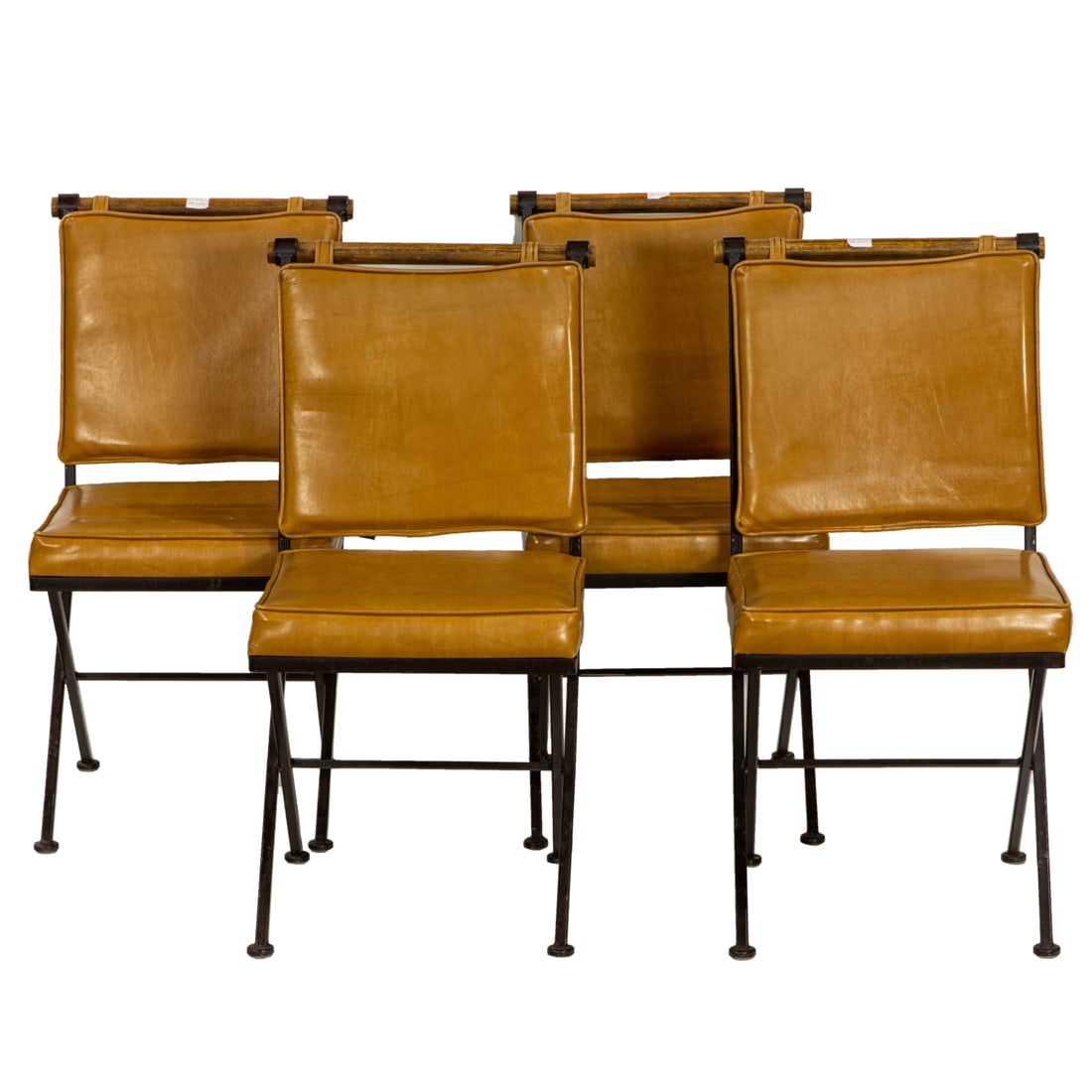 A Modern set of four Cleo Baldon style wrought iron campaign chairs, Inca Products: A Modern set of four Cleo Baldon style wrought iron campaign chairs, Inca Products, each 'x' form chair fitted with a oak crestrail, over three horizonal splats, with camel colored vinyl cushions, 33.