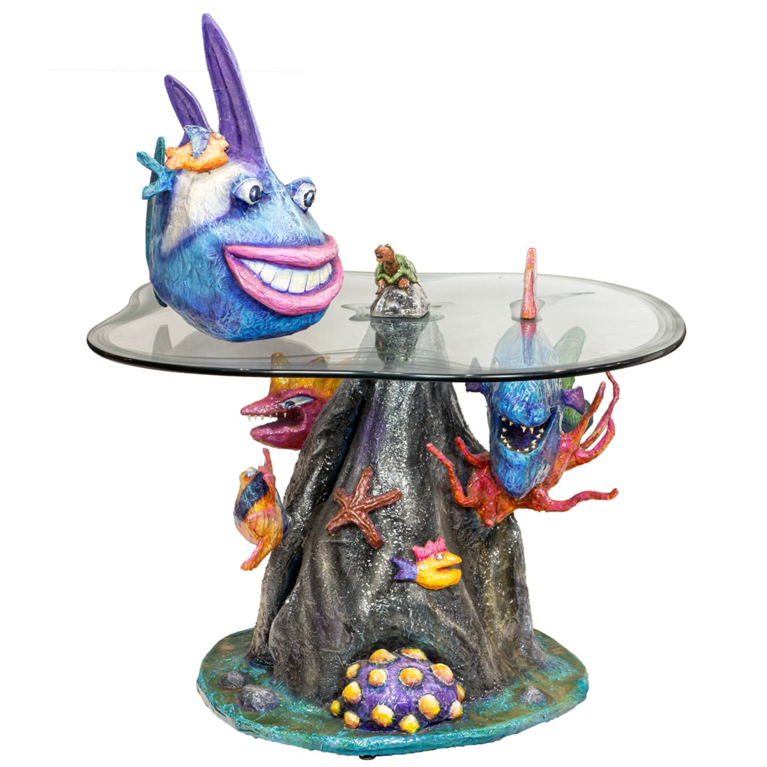 A contemporary mixed media tropical fish center table: A contemporary mixed media tropical fish center table, with a partial etched glass top with animated sea creatures, above the base depicting sea life in multiple colors, appears unsigned, overall 47"h